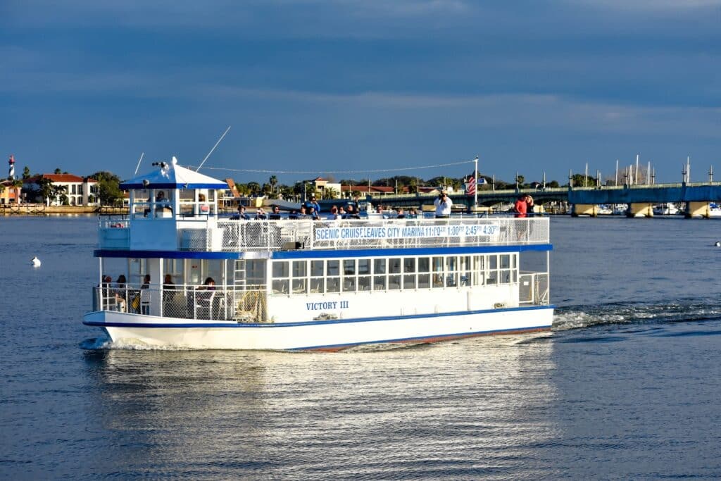 Guests enjoy a scenic cruise across Matanzas Bay during one of the popular St. Augustine boat tours, with waterfront views and historic landmarks in the distance.