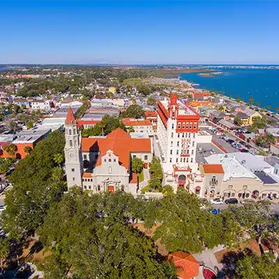 Aerial view of Flagler College's historic, red-roofed Spanish Renaissance architecture in St. Augustine, Florida.