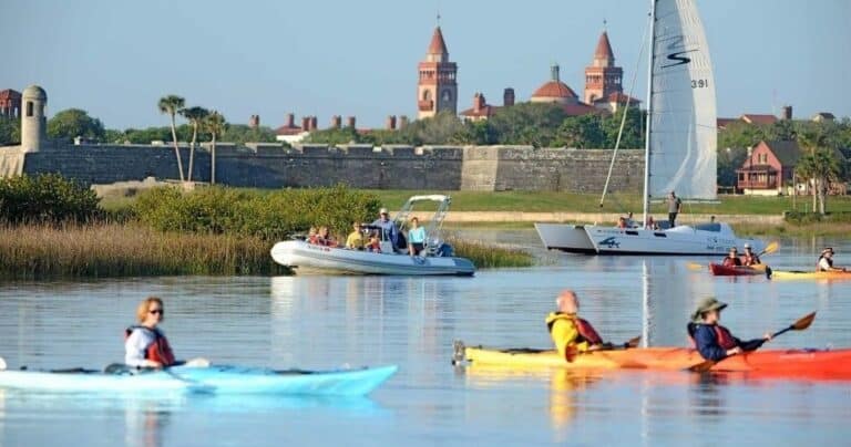 People kayaking and boating near the historic Castillo de San Marcos in St. Augustine, Florida.