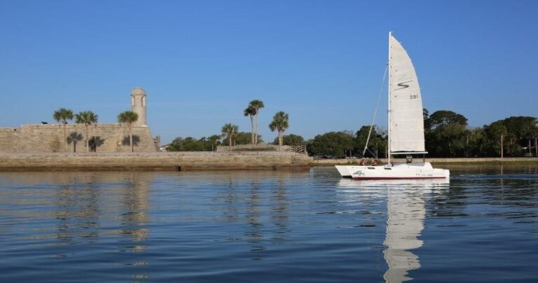 A sailboat on the water near the historic Castillo de San Marcos fort in St. Augustine, Florida.